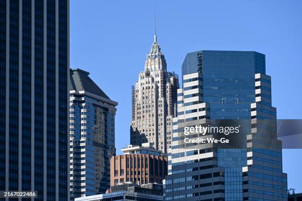 financial district of new york with the 70 pine skyscraper, built in 1932, seen from the east river. - american international building stock pictures, royalty-free photos & images