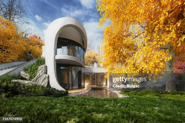 contemporary home surrounded by vibrant autumn landscape - kleurcorrectie stockfoto's en -beelden