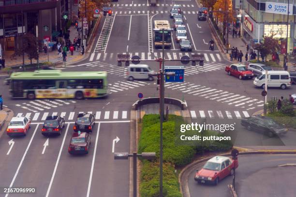 rush hours at the kyoto tower intersection - train intersection stock pictures, royalty-free photos & images
