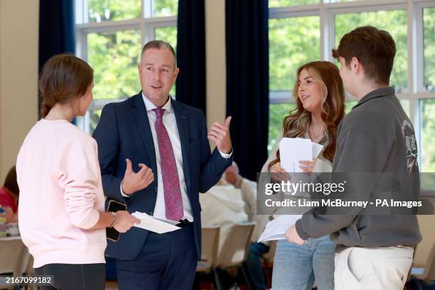 Stormont Education Minister Paul Givan speaks with pupils Ruby McClements , Darcie McCullough and Nathan Davis at Dromore High School in Dromore,...