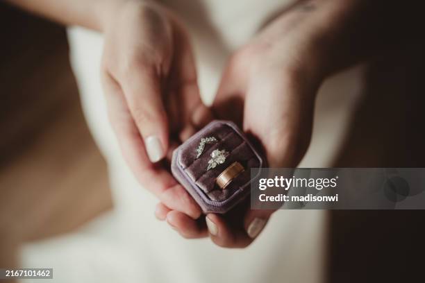 braut mit lila samtringschachtel mit verlobungsring und eheringen - schmuckschatulle stock-fotos und bilder