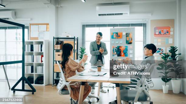 creative team celebrating successful mobile app design in office - paper prototype stock pictures, royalty-free photos & images