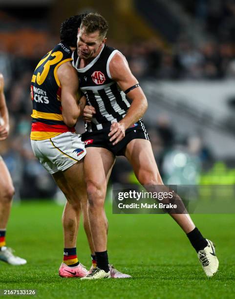 Izak Rankine of the Crows is knocked out by a late hit from Dan Houston of the Power during the round 23 AFL match between Port Adelaide Power and...