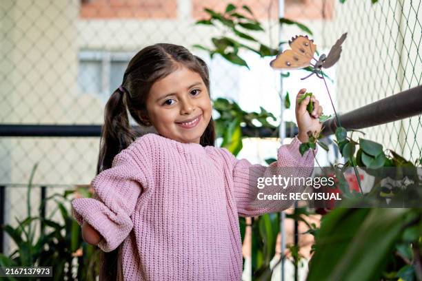 portrait of a girl looking at the camera in the courtyard of her apartment. - amputee stock pictures, royalty-free photos & images