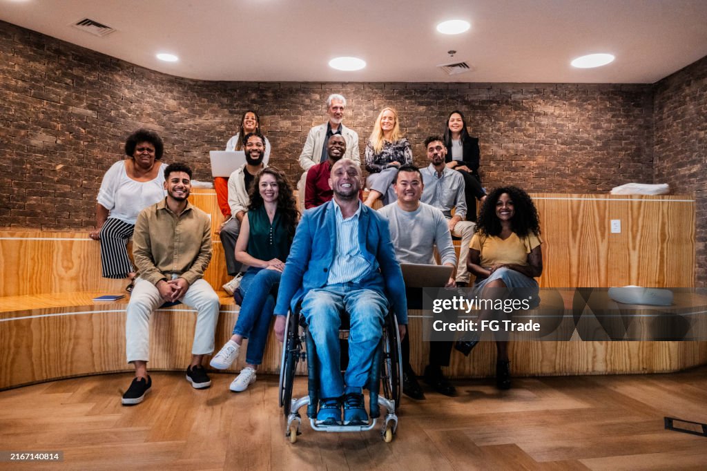 Portrait of a businessman and coworkers during presentation at office