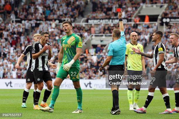 Referee, Craig Pawson shows a red card to Fabian Schaer of Newcastle United during the Premier League match between Newcastle United FC and...