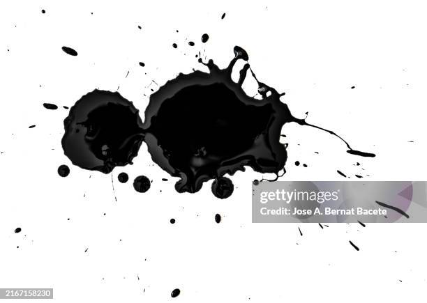 drops and splashes of black embossed acrylic paint sliding on a white canvas. - ink blots stock pictures, royalty-free photos & images