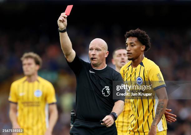 Referee Simon Hooper shows Ashley Young of Everton a red card during the Premier League match between Everton FC and Brighton & Hove Albion FC at...