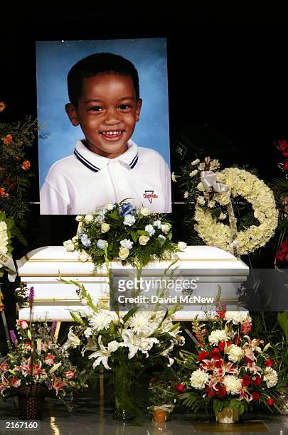 Picture of 4-year-old Marques Juwan Harperis displayed over his casket at the funeral for him and four family members who were found shot to death in...