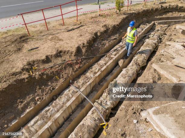 repairing old district heating pipeline in concrete trench - ondergrond stockfoto's en -beelden
