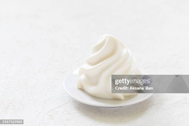vanilla cream pudding, panna cotta in the form of french chantilly cream, on a plate. light grey background. close up. copy space - whipped cream stock pictures, royalty-free photos & images