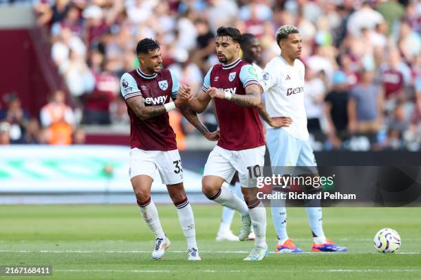 Lucas Paqueta of West Ham United celebrates scoring his team's first goal from the penalty spot with teammate Emerson Palmieri after Tomas Soucek of...