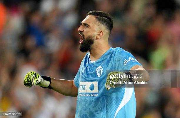 Giorgi Mamardashvili of Valencia CF celebrates after teammate Hugo Duro scores his team's first goal during the La Liga match between Valencia CF and...