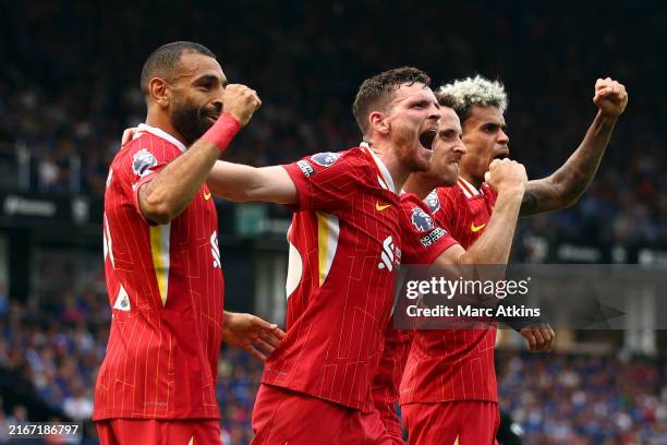 Diogo Jota of Liverpool celebrates scoring his team's first goal with teammates Mohamed Salah , Andy Robertson and Luis Diaz during the Premier...