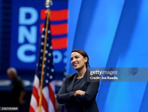 Rep. Alexandria Ocasio-Cortez walks through the stage before the start of the Democratic National Convention on August 17 in Chicago, Illinois. The...