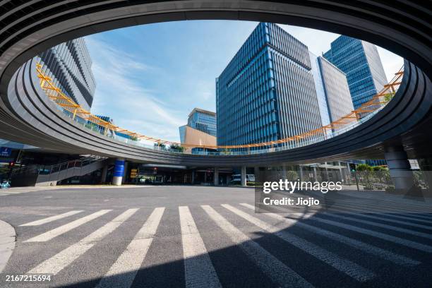 city street below the footbridge - building bottom view stock pictures, royalty-free photos & images