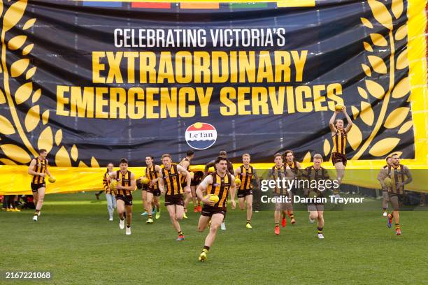 Hawthorn players run out before the round 23 AFL match between Hawthorn Hawks and Richmond Tigers at Melbourne Cricket Ground, on August 18 in...