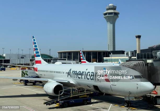 An American Airlines Boeing 737-823 passenger aircraft sits at a gate at Chicago O'Hare International Airport on August 23, 2024 in Chicago, Illinois.