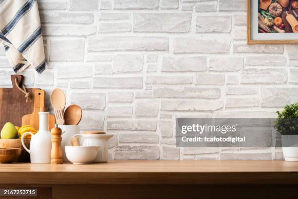 kitchen countertop with utensils and brick wall background. copy space available - cafe counter wall stock pictures, royalty-free photos & images