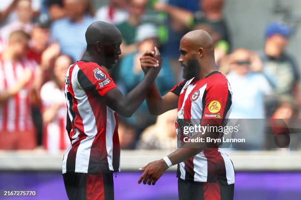 Yoane Wissa of Brentford celebrates scoring his team's second goal with teammate Bryan Mbeumo during the Premier League match between Brentford FC...