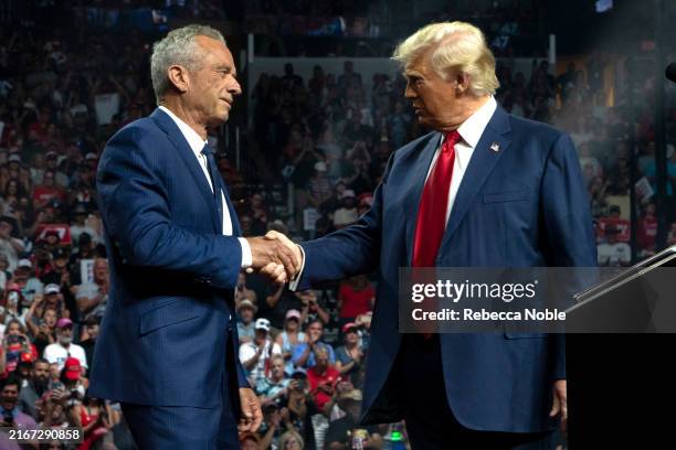 Former Republican presidential candidate Robert F. Kennedy Jr. And Republican presidential nominee, former U.S. President Donald Trump shake hands...