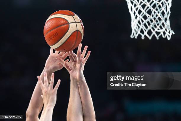 Two pairs of hands reach up to grab a rebound during the Australia V Belgium Women's Basketball Bronze Medal Game at the Bercy Arena during the Paris...