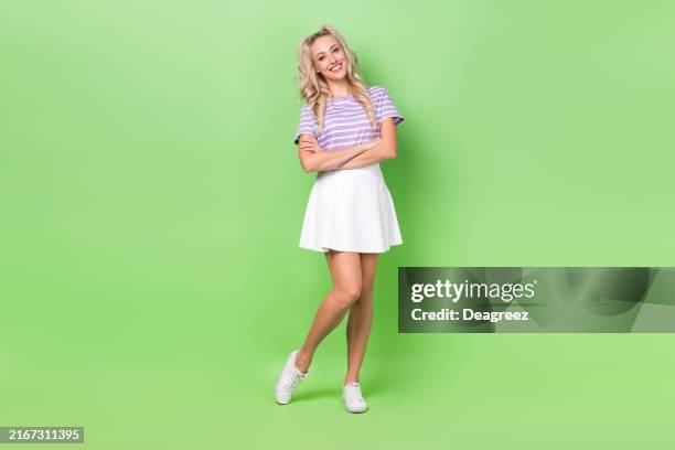 Full length photo of positive confident girl wear violet t-shirt smiling arms crossed isolated green color background