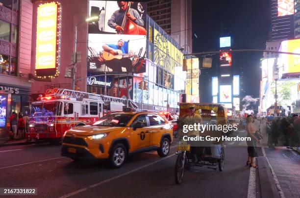 Pedicab drives through Times Square on August 17 in New York City.