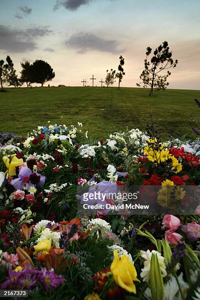 Flowers cover the gravesite of five family members who were found shot to death in their home last week July 16, 2003 in Bakersfield, California. The...