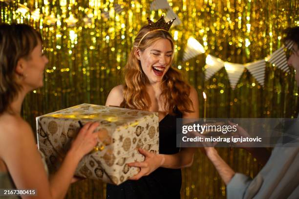young woman receiving gifts for her birthday in a nightclub - birthday crown stock pictures, royalty-free photos & images
