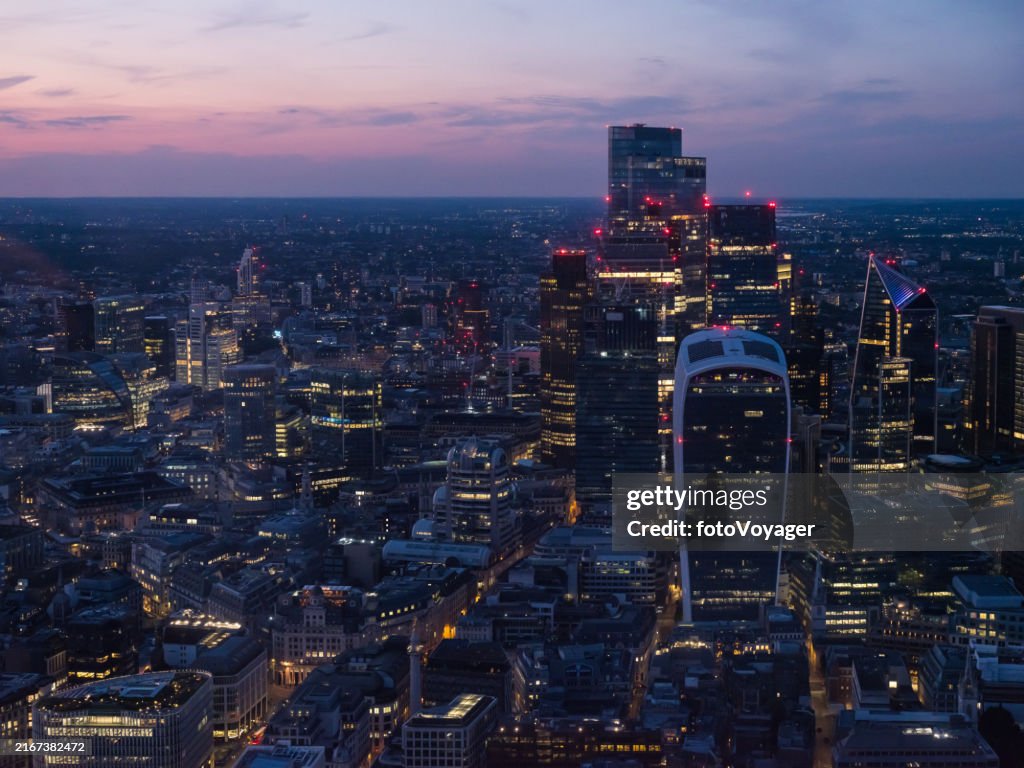 London aerial photograph over City Financial District skyscrapers glittering sunset