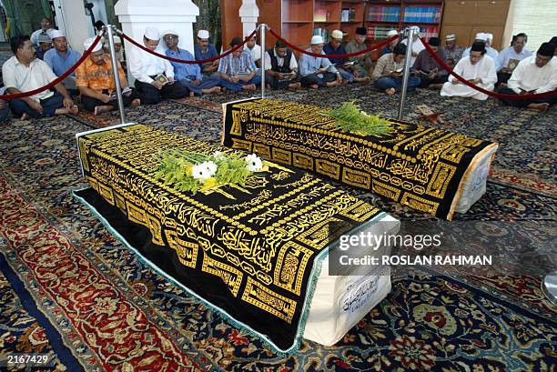 The coffins of Iranian twins Ladan and Laleh Bijani are laid on the hall of Ba'Alwi Mosque in Singapore, 09 July 2003. The bodies of Ladan and Laleh...