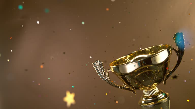 Exploding Trophy Super Slow Motion. Champion Golden Trophy with Exploding Gold Glitters ...