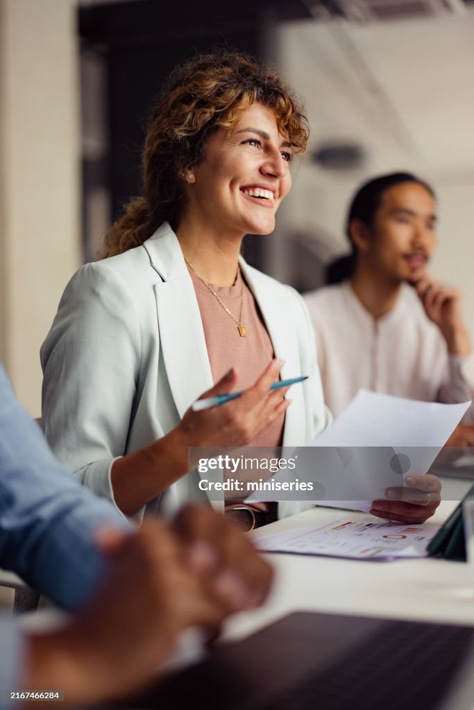 Smiling Businesswoman in a Team Meeting at the Office