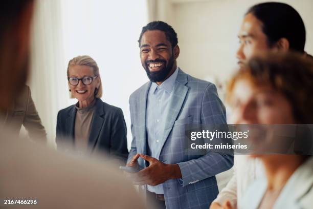 diverse group of professionals collaborating in modern office - leader stock pictures, royalty-free photos & images