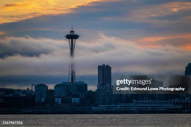 seattle waterfront and the space needle shrouded in early morning fog. - space needle stock pictures, royalty-free photos & images