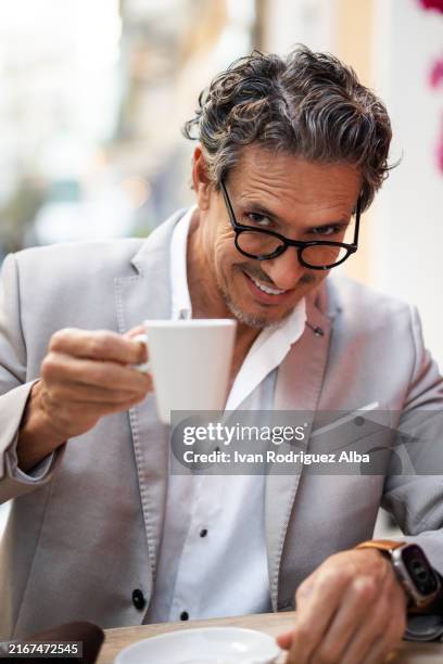 businessman toasting with coffee looking at camera outdoors - honour board stock pictures, royalty-free photos & images