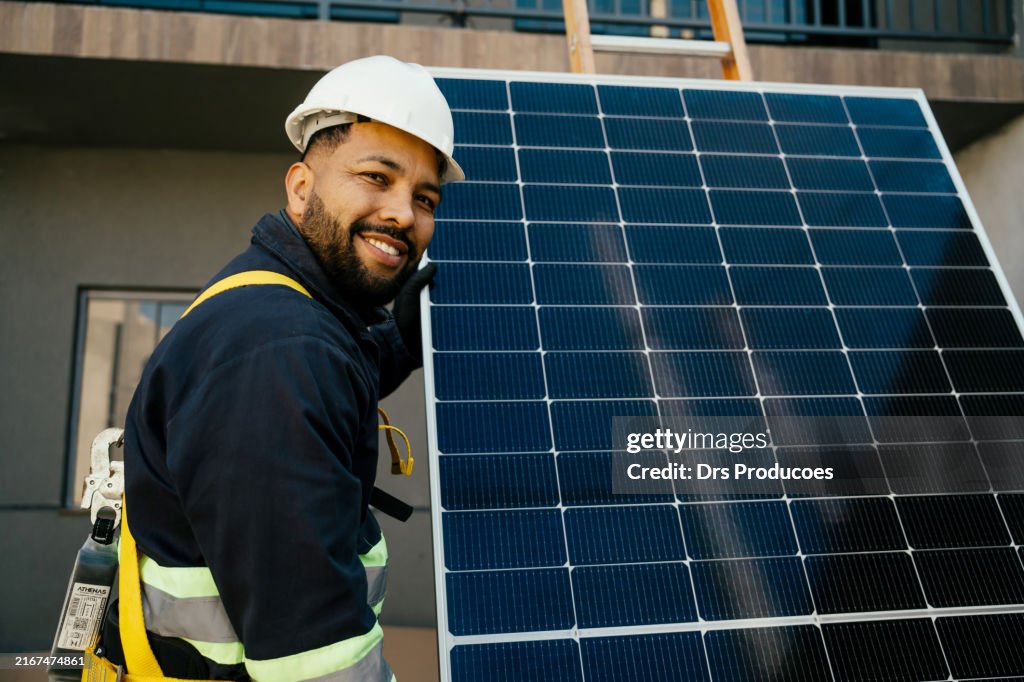 Worker holding solar panel,