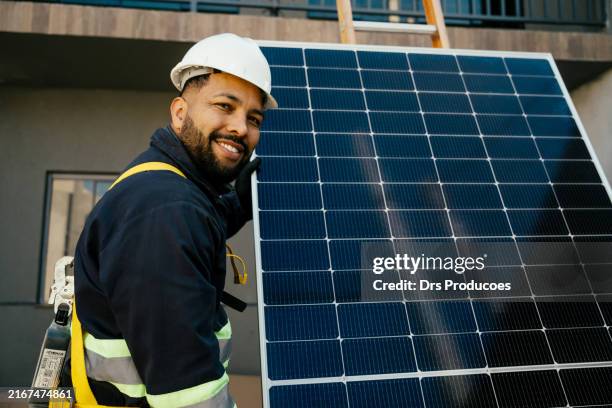 worker holding solar panel, - clean tech stock pictures, royalty-free photos & images