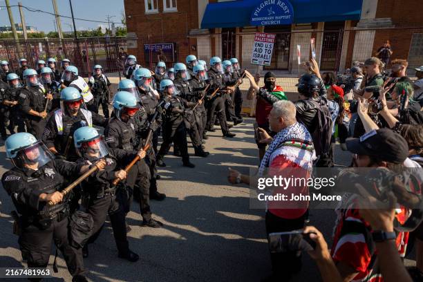 Chicago police move in on demonstrators who had tried to break through the perimeter near the Democratic National Convention at the United Center on...
