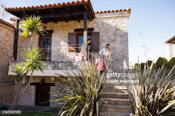 female travelers leaving vacation house - holiday villa stock pictures, royalty-free photos & images