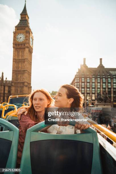 lesbian couple on the bus in london - double decker bus stock pictures, royalty-free photos & images