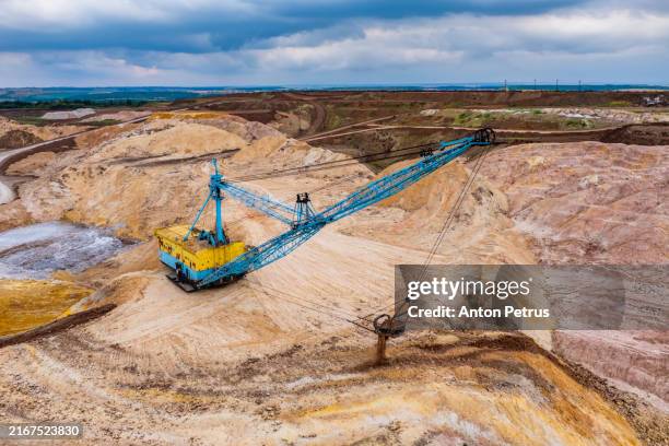 giant excavator in an open pit mine - natural phenomena stock pictures, royalty-free photos & images
