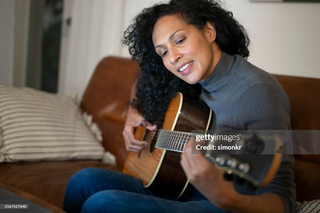 Mature woman playing guitar