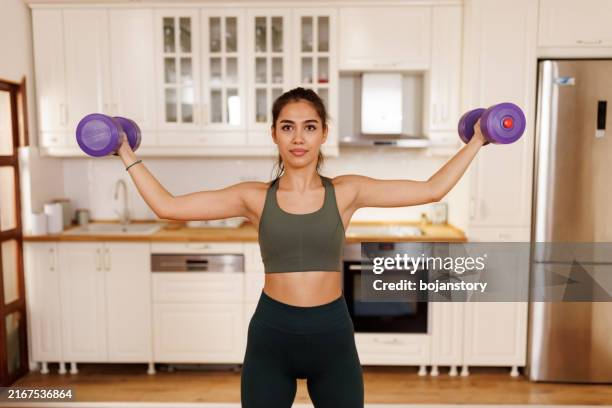 training with dumbbells at home - home workout stock pictures, royalty-free photos & images