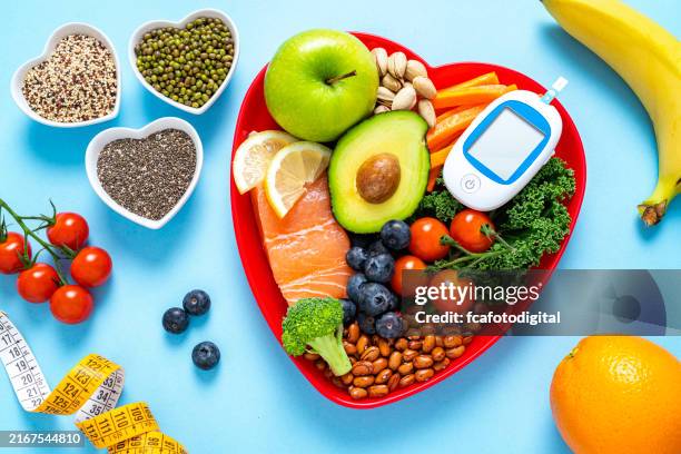 healthy eating for blood glucose control. healthy food and glucometer - cholesterol stockfoto's en -beelden