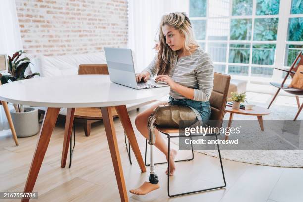 woman with amputated leg - disability computer stock pictures, royalty-free photos & images