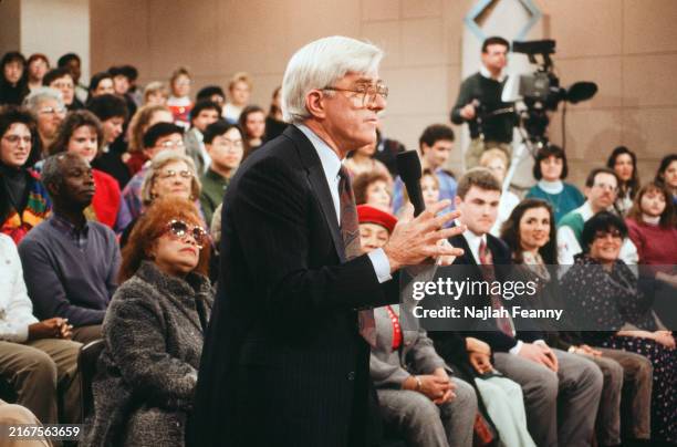 View of American talk show host Phil Donahue and audience members during the filming of an episode of 'The Phil Donahue Show' at WNBC-TV's Studio...