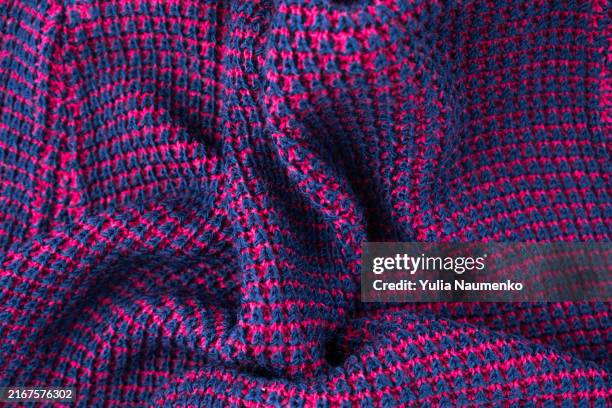 knitted fabric. texture of a knitted sweater folded in a swirling pattern. - white shirt texture stock pictures, royalty-free photos & images