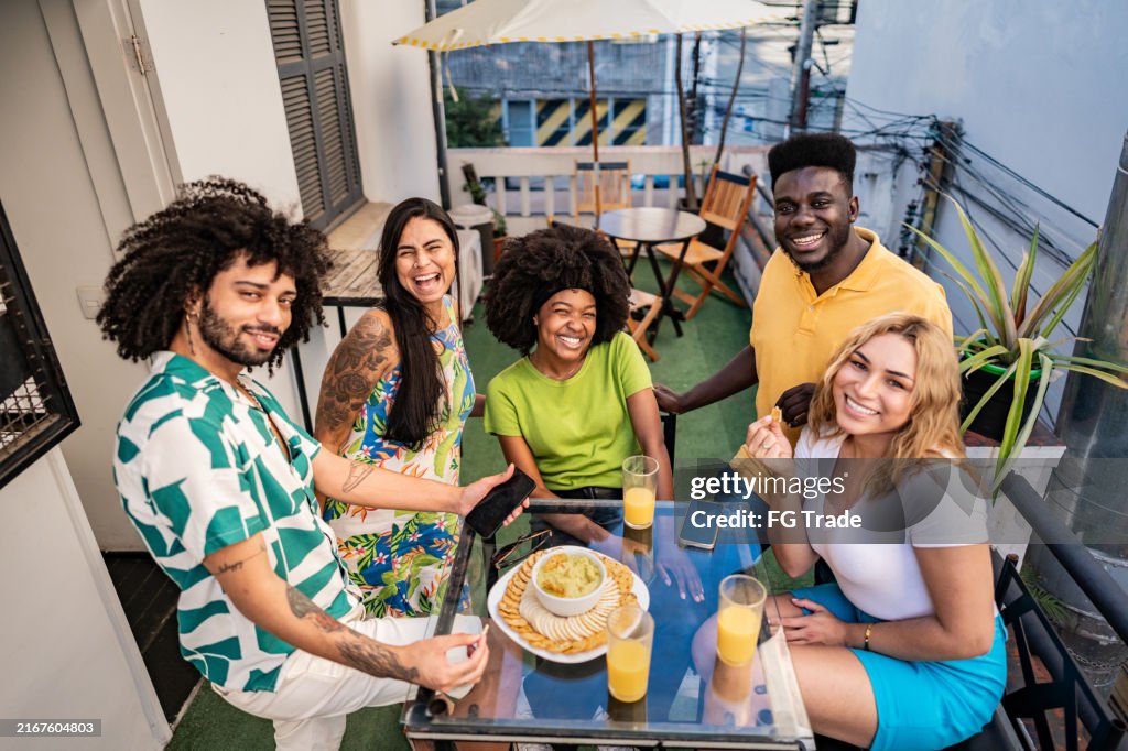 Portrait of friends eating at a hostel